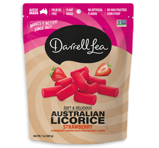 Darrell Lea Australian Licorice Strawberry in a 7 oz resealable stand-up pouch. The packaging features a pink top section with white text, a beige lower section with a swirl pattern, and an illustration of red licorice candies with strawberry graphics.