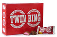 Twin Bing candy bar with two pieces cut open on a white background