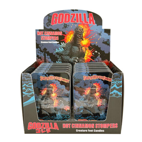 Display box of Godzilla-themed candles with packaging featuring the character.