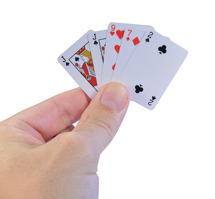 Hand holding a hand of playing cards with a white background