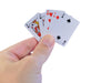 Hand holding a hand of playing cards with a white background