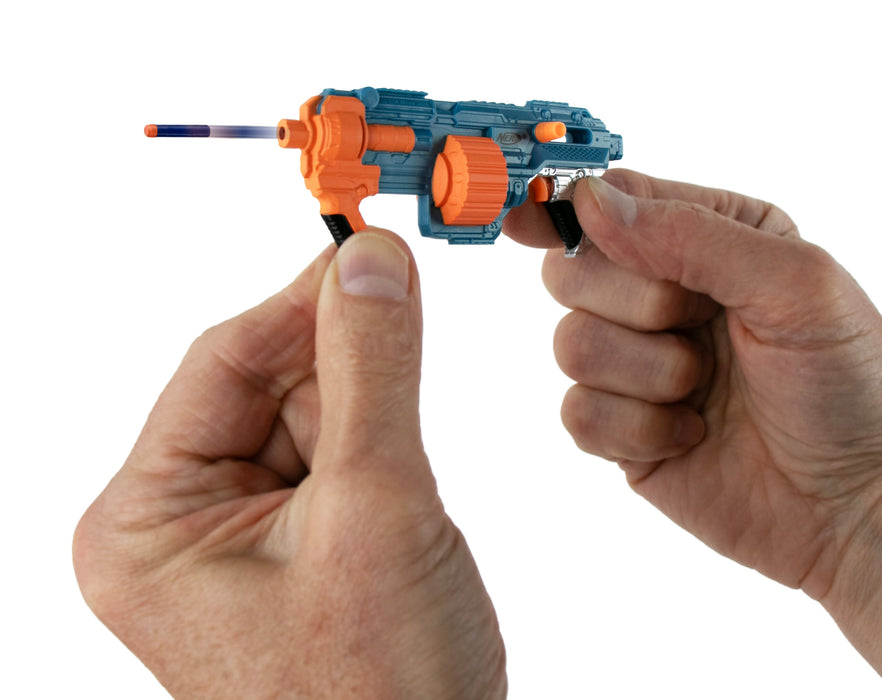 Hand holding a small blue and orange toy gun against a white background