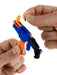 Close-up of a person assembling a blue and orange toy gun on a white background