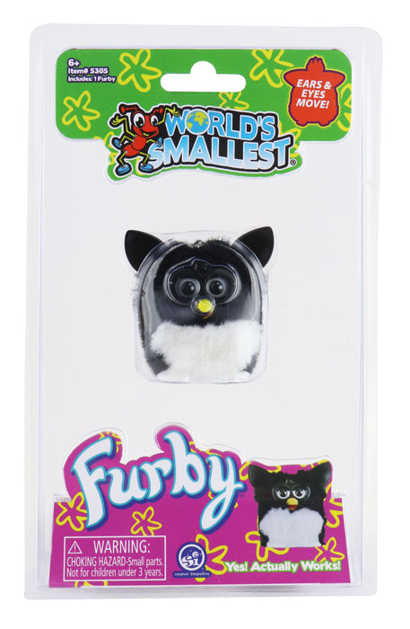 World's Mallest Furby in its original retail blister packaging, featuring a black and white plush toy with a yellow nose and moving eyes.