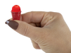 Hand holding a small red object with a white background
