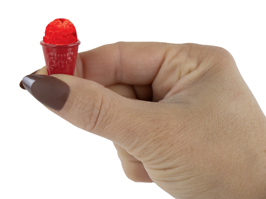 Hand holding a small red object with a white background
