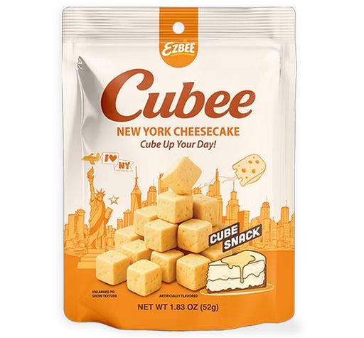 A package of Ezbee Cube New York Cheesecake cube snack pieces, in a 1.83 oz (52g) resealable stand-up pouch with an orange and white design featuring the Statue of Liberty and New York City skyline.