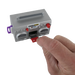 Small gray boombox toy held by a hand on a white background