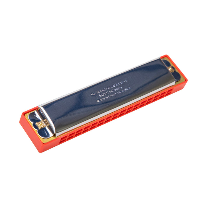 Red and metal harmonica on a white background
