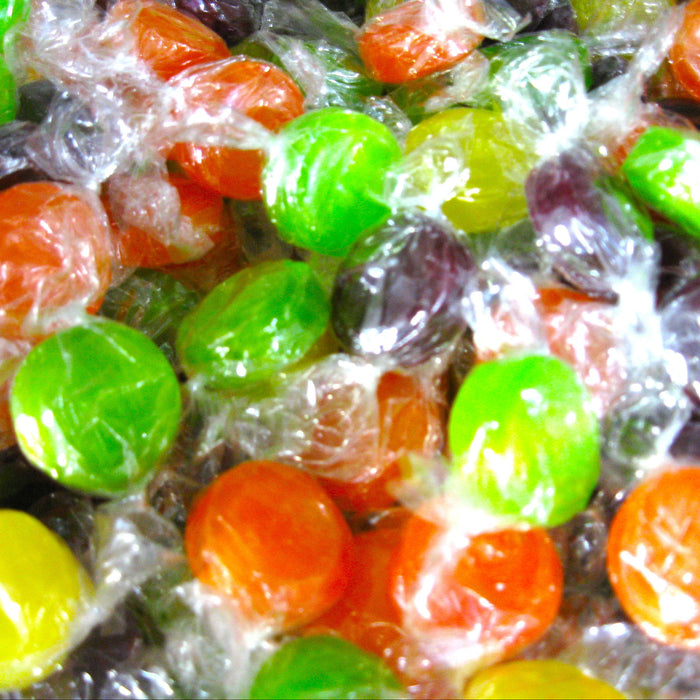 Assorted colorful candies in clear wrappers.