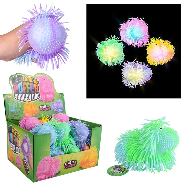 A multicolor glow-in-the-dark squishy puffer toy shown in a retail display box, with a hand holding one version, a close-up inset of several glowing balls, and one large green ball on a white background.