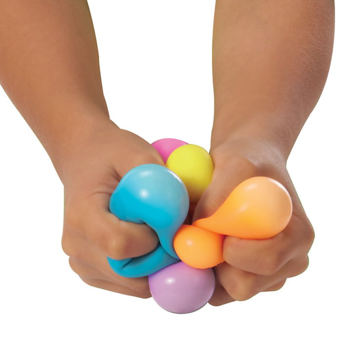 Colorful stress balls being squeezed by a child's hands on a white background