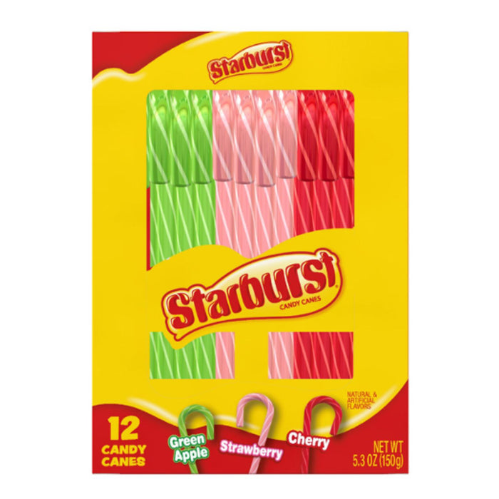 A package of Starburst candy canes in green apple, strawberry, and cherry flavors, featuring a bright yellow box with red and white branding and a clear window showing the striped candy canes inside.