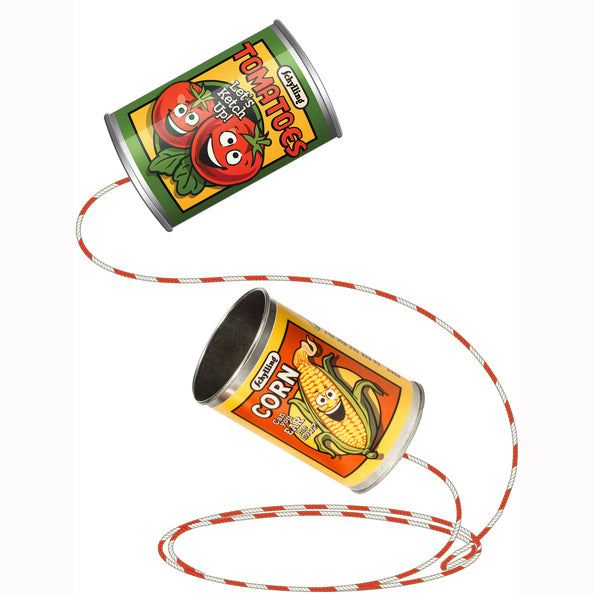 Two toy cans with tomato and corn designs on a white background