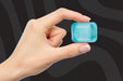 Hand Holding a Tine Nee Doh Nice Cube
