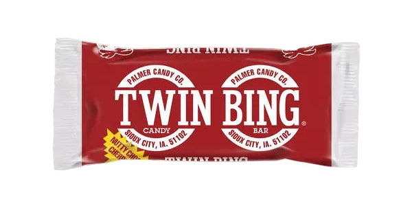 A single wrapped candy bar labeled Twin Bing by Palmer Candy Co., shown on a white marble surface.