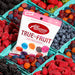 Albanese True to Fruit packaging with a background of fresh berries