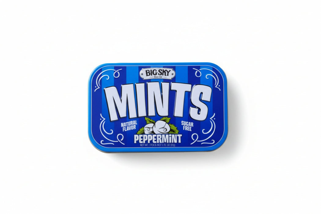 Big Sky Mints peppermint tin surrounded by mints and mint leaves on a white background