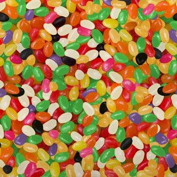 A close-up, top-down view of a dense pile of colorful jelly beans in various shapes and colors, filling the entire frame.