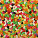 A close-up, top-down view of a dense pile of colorful jelly beans in various shapes and colors, filling the entire frame.