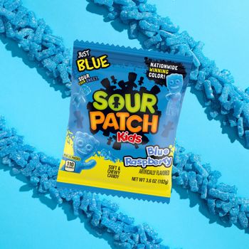 Sour Patch Kids Blue Raspberry candy package on a blue background with blue gummy worms.