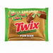 Twix Ghoulish Green Fun Size Cookie Bars in a green and gold wrapper, featuring illustrations of chocolate-coated Twix bars and a broken bar showing the green filling.