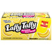 A box of Laffy Taffy Candy Stretchy and Tangy Banana flavored bars, featuring bright yellow packaging with illustrations of bananas and the brand logo.