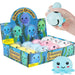 A retail display box filled with small squishy octopus toys, with a hand holding one light blue octopus above the box. The display packaging is blue with cartoon octopus graphics and the words 'Squeeze Octopus.