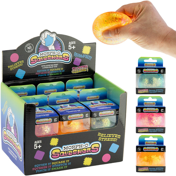 A display box of Morphe-O Squashers stress squishies alongside a hand holding a glowing orange squishy and three individual packaged units on a white background.